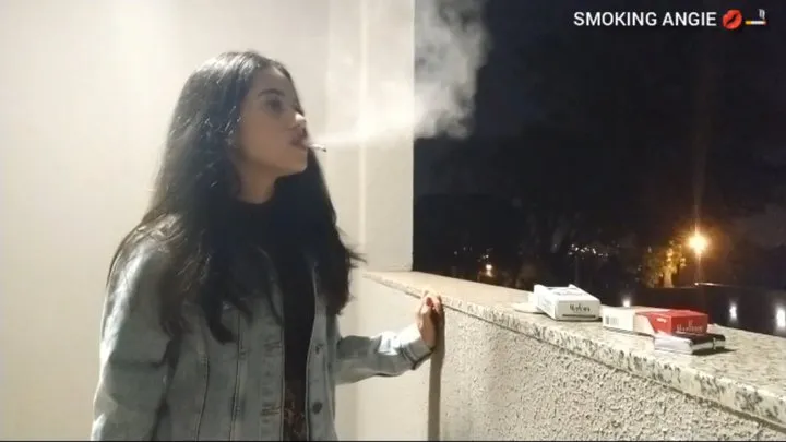 Angie dangling smoking a cork in the balcony