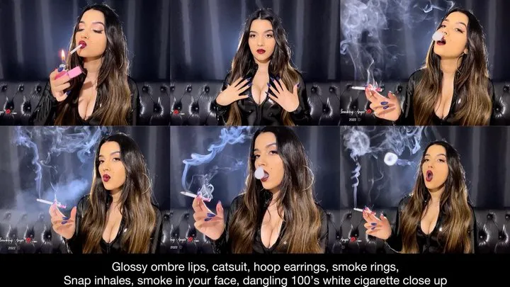 Ombre lips, pvc catsuit, hoop earrings, smoke rings, snap inhales, smoke in your face, long nails, dangling 100's white cigarette close up!