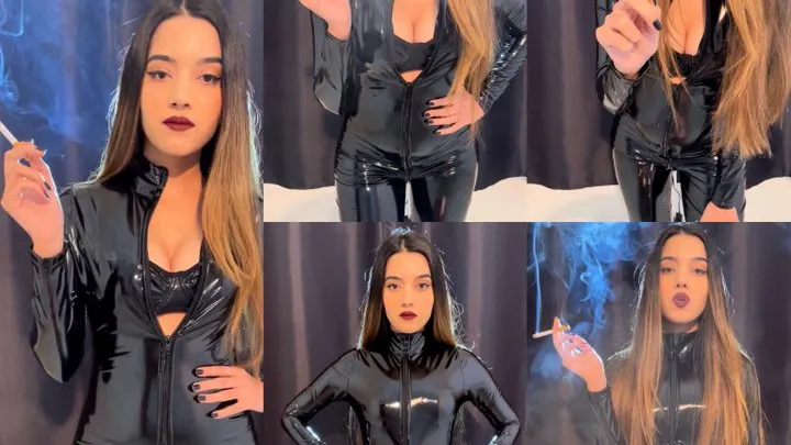 Human ashtray in a leather catsuit