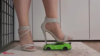 Mila - Toy car crushing in silver heels (view01)