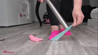 Mila vacuuming lego and socks