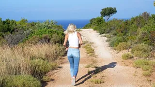 Wetting her Jeans bare foot on island hike