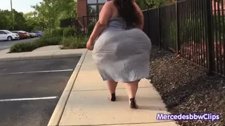 Native Pear Walking outside in a tight dress