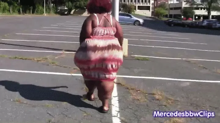 Chocolate Pear walking outside in a tight dress