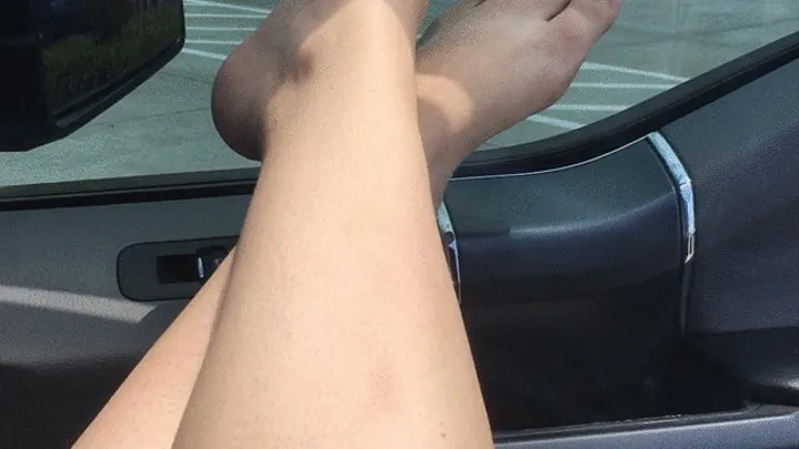 Public Foot Play in the Car in a Busy Parking Lot of a Shopping Center