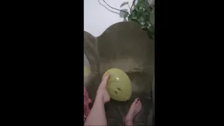 Playing with smiley balloon