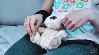 Socked teen girl playfully crushing a plush toy puppy - 4K MP4