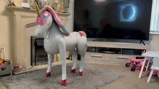 Foil unicorn balloon sit popping