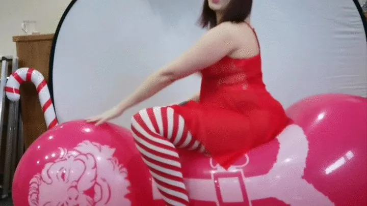 Miss Santa blowing Santa's big balloon