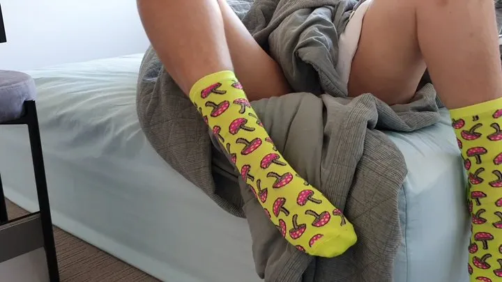 Cute Girl in Bright Socks Stuck in Bed