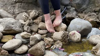 RELAXING HER PETITE FEET IN A FOUNTAIN