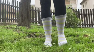 WALKING ON GRASS IN HER SOCKS