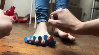 PAINTING HER TOE NAILS RED