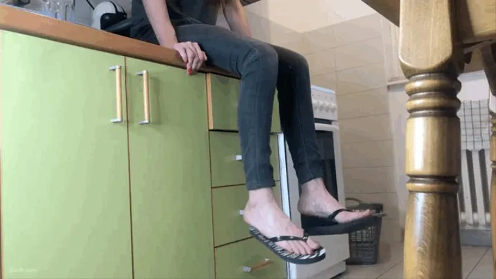 TWO GIRLS FLIP FLOPS DANGLING ON A KITCHEN COUNTER (LONG)