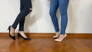 TWO GIRLS WEARING HEELS STEPPING ON EACH OTHER'S FEET