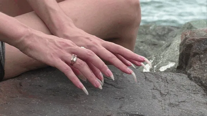 Scratching a huge stone on the beach with my nails