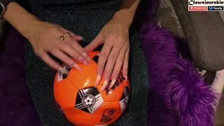 Nails scratching the soccer ball hard and finally puncture