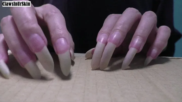 nails aggressively scratching cardboard