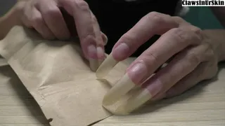 making a holes with my nails in the wrapping paper