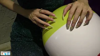 Nails scratching, puncture and destroying beach balls
