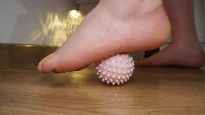 Playing with a massage ball | Close-up of a foot