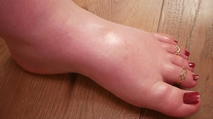 Left foot in oil with red pedicure - (no talking)