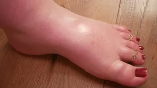 Left foot in oil with red pedicure - (no talking)