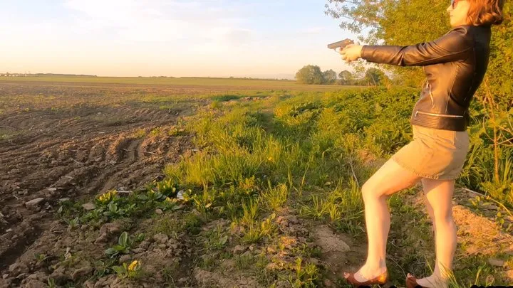 Sexy girl shoots from a real combat pistol
