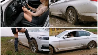 Car stuck in in deep soft mud in luxury while BMW