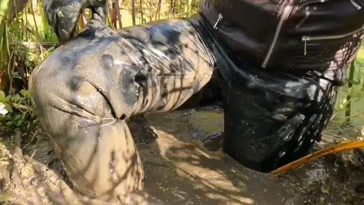 Sexy girl in all leather clothes stuck in deep mud