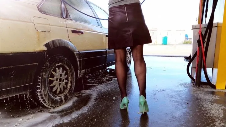 Sexy babe in pantyhose and mint high heels is washing car