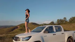 Bruna dances on the roof and hood of a Hilux and also revvs it hard