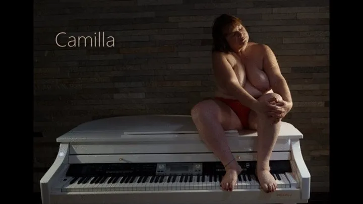 Camilla spreads her fabulous fat on top of a small piano