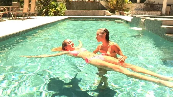 Hot babes tease each other in the swimming pool until they carry it on to the living room