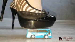 High heels crushing toy bus