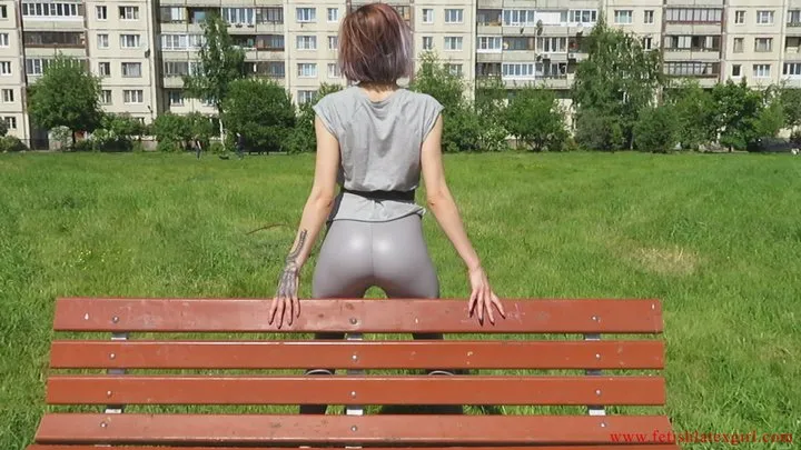 Brunette Natalia in gray leggings and a tight ass posing on a bench and reading poetry