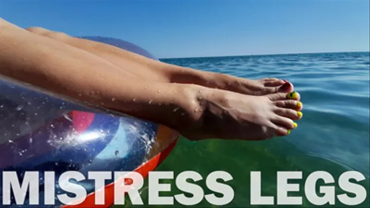 Sexy bare feet and colored toenails on the sea