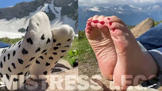 Foot teasing in white socks and barefoot on the top of the mountain