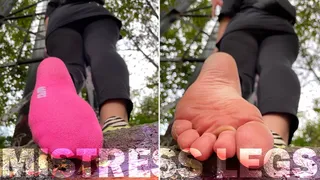 Pink socks and natural rough wrinkled soles above you outdoor