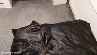 Dressed in womens leathers jerking off onto a leather jacket on a leather bed (Lots of cum)