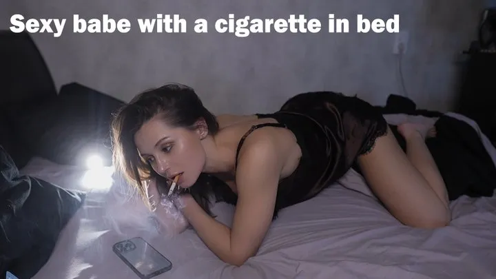 Sexy babe with a cigarette in bed