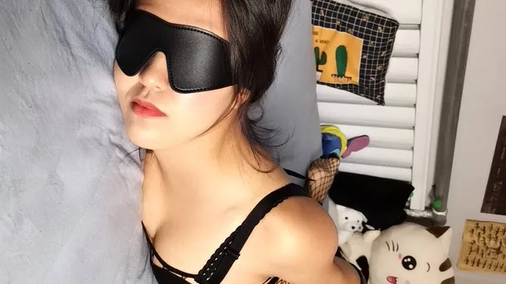 Blindfolded bitch tied hands and feet on bed