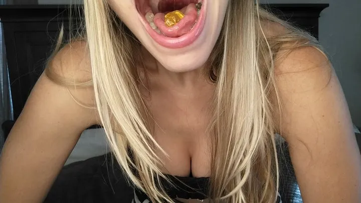 Open mouth swallowing gummy bears