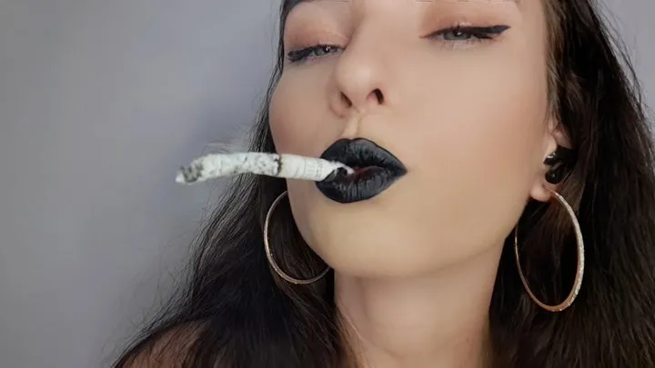 Sultry brunette with black lips smokes up close to your face: Miss Sara