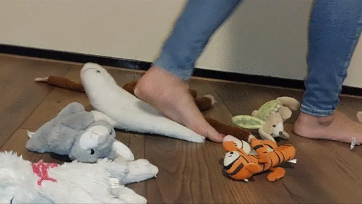 Sandra is walking all over a bunch of plushies crushing them flat with her bare feet