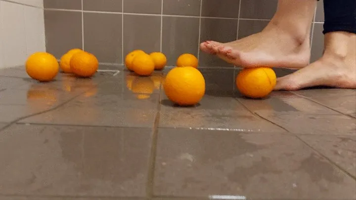 Sandra is crushing oranges with her sexy bare feet