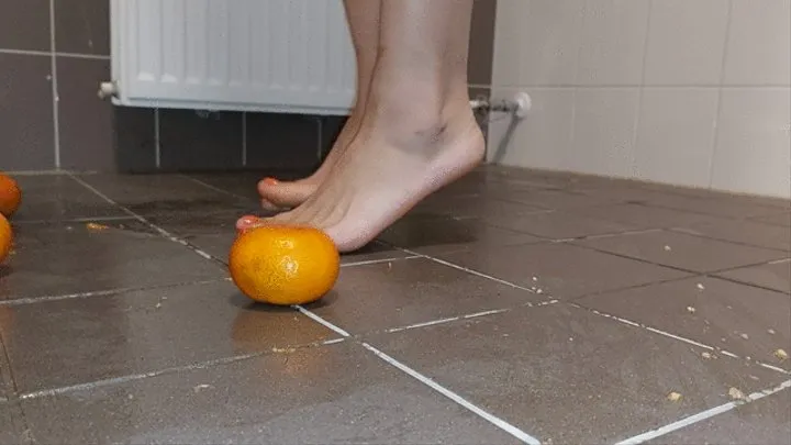 Sandra is crushing banana's and oranges barefoot