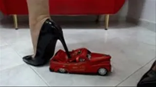 crushing a toycar in black stiletto heels