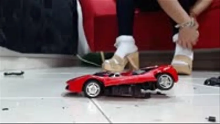 crushing hard the rastar Ferrari 458 Italia in wooden heel sandals and socks in jeans