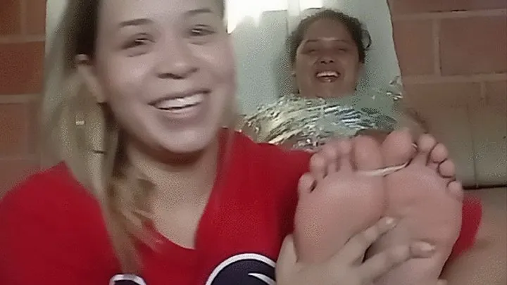 Teresa tickles cousin Marbelis's feet